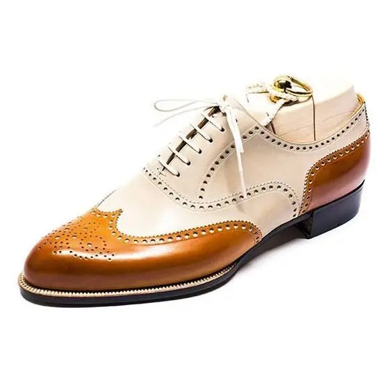 Tan and white wingtip dress shoes for men