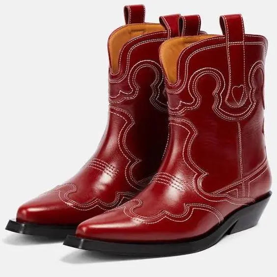 Burgundy leather cowboy boots with pointed toe and decorative stitching