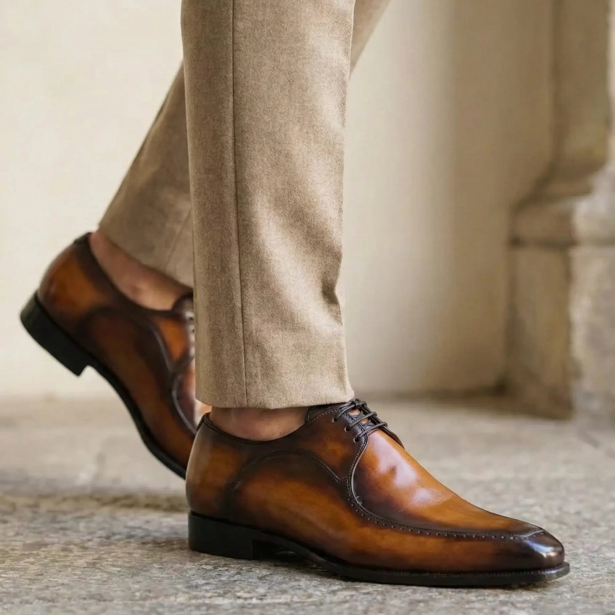 Tan brown hand-painted patina leather derby shoes showing tonal depth and variation