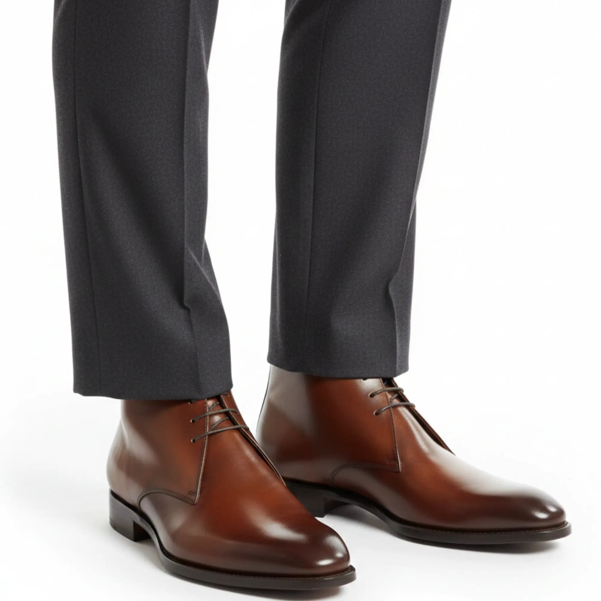 Brown leather chukka boots worn with charcoal suit trousers