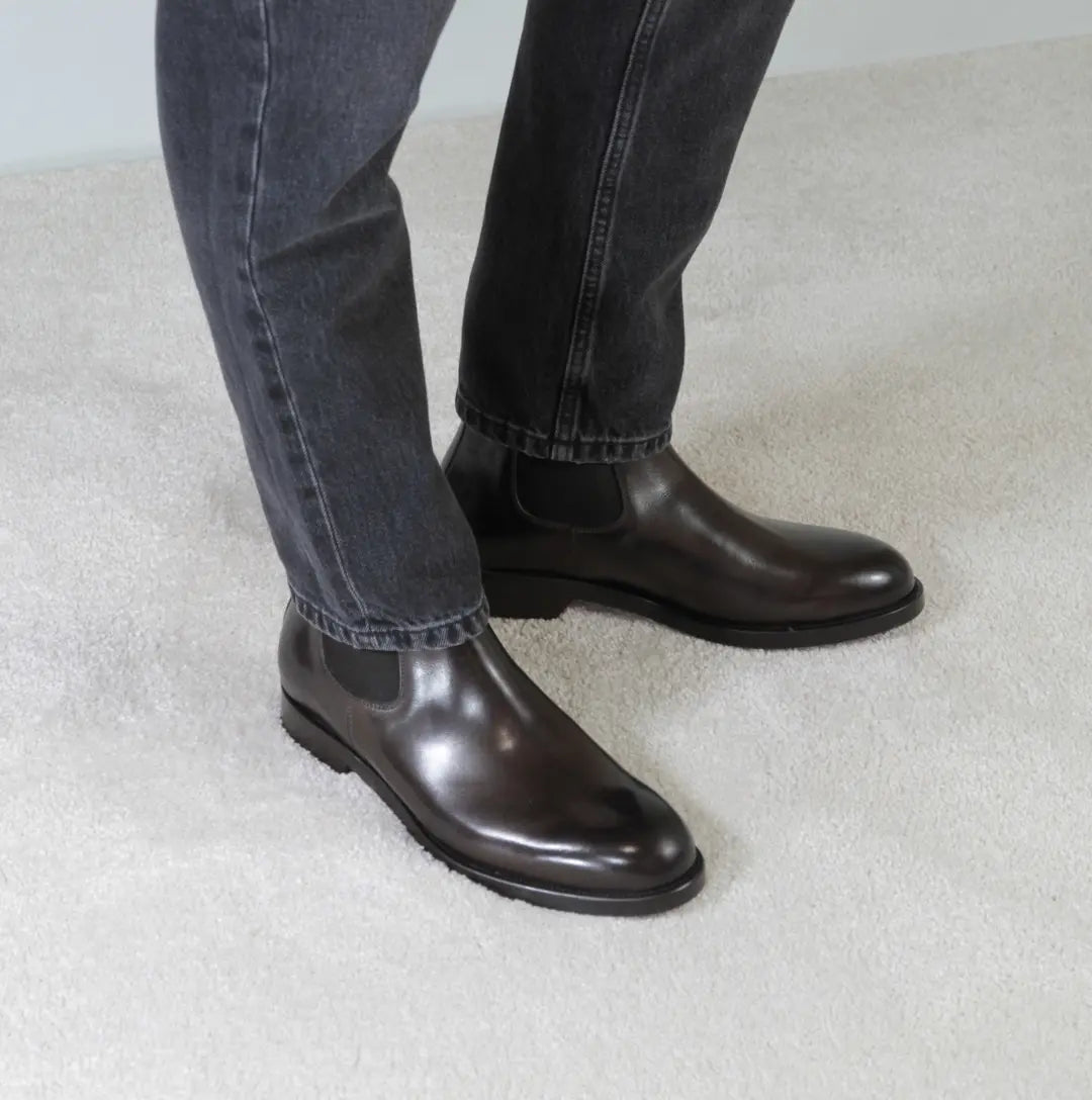 Brown leather Chelsea boots styled with grey denim jeans