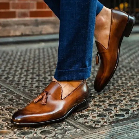 Maroon leather tassel loafers styled with tailored trousers